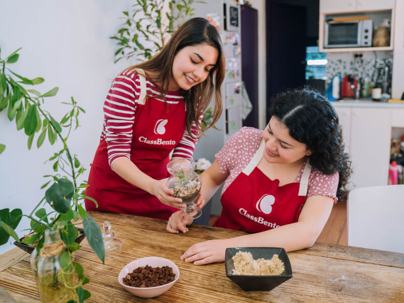 Two women making a terrarium in a terrarium workshop